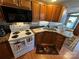 Well-equipped kitchen featuring a stove, microwave, and double sink at 108 Meadowview Cir, New London, NC 28127