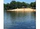 Sandy lakeside beach with a gazebo and playground at 108 Meadowview Cir, New London, NC 28127