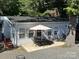 House exterior with patio set, and tree-filled surroundings at 108 Meadowview Cir, New London, NC 28127