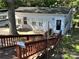 Single-story home with patio, stairs and surrounding trees at 108 Meadowview Cir, New London, NC 28127