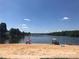 Sandy lakeside beach with picnic umbrellas at 108 Meadowview Cir, New London, NC 28127