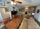 Open living area with a comfortable couch and adjacent dining area at 108 Meadowview Cir, New London, NC 28127