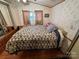 Cozy bedroom featuring a double bed, dresser, and wood floors at 108 Meadowview Cir, New London, NC 28127