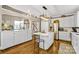 Bright kitchen boasts white cabinets, an island, and hardwood floors at 5610 Golden Pond Dr, Indian Trail, NC 28079