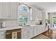 Well-equipped kitchen with white cabinets and a large sink at 5610 Golden Pond Dr, Indian Trail, NC 28079