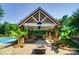 Outdoor kitchen and seating area under a covered pavilion next to the pool at 5610 Golden Pond Dr, Indian Trail, NC 28079