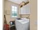 Laundry room with washer, dryer, cabinets, and window at 5610 Golden Pond Dr, Indian Trail, NC 28079