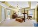 Spacious bedroom with a post bed, carpet flooring, and large windows at 5610 Golden Pond Dr, Indian Trail, NC 28079