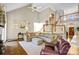 Two-story living room with vaulted ceilings, hardwood floors, and a large sectional sofa at 5610 Golden Pond Dr, Indian Trail, NC 28079