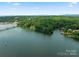 Aerial view showcasing waterfront property and surrounding landscape at 144 Hickory Hollow Ln, Taylorsville, NC 28681