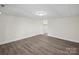 Finished basement room with vinyl flooring and access to closet at 144 Hickory Hollow Ln, Taylorsville, NC 28681