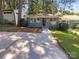 Cute bungalow with gray brick exterior and a walkway at 1913 Herrin Ave, Charlotte, NC 28205