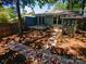 Landscaped backyard with stone pathway and wooden deck at 1913 Herrin Ave, Charlotte, NC 28205