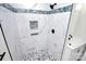 Marble shower with blue mosaic trim and pebble floor at 508 Northern St, Shelby, NC 28150