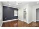 Bedroom with dark wood floors, navy blue accent wall, and en-suite bathroom at 508 Northern St, Shelby, NC 28150