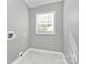 Well-lit laundry room with marble-look flooring and a window at 508 Northern St, Shelby, NC 28150