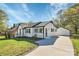 Newly renovated white brick house with dark trim, a spacious yard, and detached garage at 508 Northern St, Shelby, NC 28150