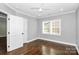 Simple bedroom with dark hardwood floors and a window at 508 Northern St, Shelby, NC 28150