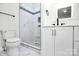 Clean bathroom with white cabinets, marble shower, and pebble floor at 508 Northern St, Shelby, NC 28150
