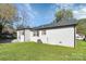 Side view of the house showcasing the white brick exterior, brown shutters, and a large backyard at 508 Northern St, Shelby, NC 28150