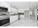 Modern white kitchen features stainless steel appliances and marble-look flooring at 508 Northern St, Shelby, NC 28150