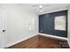 Spacious bedroom with dark wood flooring and a navy blue accent wall at 508 Northern St, Shelby, NC 28150