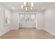 Formal dining room with hardwood floors, chandelier and bay window at 5723 Heirloom Crossing Ct, Charlotte, NC 28270