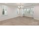 Bright dining room with hardwood floors, chandelier, and window shutters at 5723 Heirloom Crossing Ct, Charlotte, NC 28270