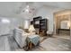 Living room with vaulted ceiling, built-in shelving, and neutral decor at 303 Lincoln Rd, York, SC 29745