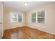 Bright bedroom with hardwood floors and multiple windows at 805 Rowan Avenue Ext, Spencer, NC 28159