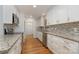 Modern kitchen featuring granite countertops and white cabinetry at 805 Rowan Avenue Ext, Spencer, NC 28159