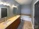 Bathroom with double vanity, garden tub, and neutral tile flooring at 210 Harbour Place Dr, Davidson, NC 28036