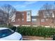 Rear view of townhome showing brick exterior and garages at 210 Harbour Place Dr, Davidson, NC 28036