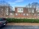 Rear view of townhome showing brick exterior and garages at 210 Harbour Place Dr, Davidson, NC 28036