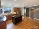 Kitchen with island, hardwood floors, and dark brown cabinets at 210 Harbour Place Dr, Davidson, NC 28036