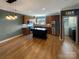 Modern kitchen with island, stainless steel appliances, and hardwood floors at 210 Harbour Place Dr, Davidson, NC 28036