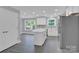 Modern kitchen with white cabinets, island, and stainless steel appliances at 8433 Rittenhouse Cir, Charlotte, NC 28270