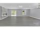 Finished basement with fireplace, sliding glass doors, and grey flooring at 8433 Rittenhouse Cir, Charlotte, NC 28270