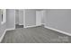 Bedroom with grey walls, laminate flooring, and ensuite bath at 8433 Rittenhouse Cir, Charlotte, NC 28270