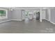 Open living room with kitchen view and grey flooring at 8433 Rittenhouse Cir, Charlotte, NC 28270