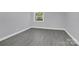 Spacious bedroom with grey laminate flooring and neutral walls at 8433 Rittenhouse Cir, Charlotte, NC 28270