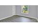 Well-lit bedroom with a window and wood-look flooring at 8433 Rittenhouse Cir, Charlotte, NC 28270