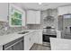 Modern kitchen with white cabinets and stainless steel appliances at 8433 Rittenhouse Cir, Charlotte, NC 28270
