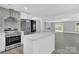 Modern kitchen with island, stainless steel appliances and open floor plan at 8433 Rittenhouse Cir, Charlotte, NC 28270