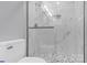 Walk-in shower with marble tile and penny round floor at 8433 Rittenhouse Cir, Charlotte, NC 28270