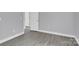 Bedroom with grey walls, wood-look flooring, and access to another room at 8433 Rittenhouse Cir, Charlotte, NC 28270