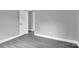 Simple bedroom with grey walls and wood-look flooring at 8433 Rittenhouse Cir, Charlotte, NC 28270