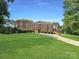 Brick home with large yard and driveway at 9100 Woodhall Lake Dr, Waxhaw, NC 28173
