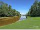 Serene pond view with lush greenery at 9100 Woodhall Lake Dr, Waxhaw, NC 28173