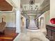 Grand entry with curved staircase and chandelier at 9100 Woodhall Lake Dr, Waxhaw, NC 28173